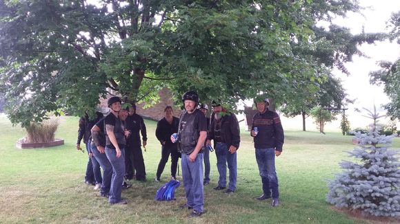 A wet riding group hiding under a tree waiting for the downpour to pass. After 15 mins we were on our way again!