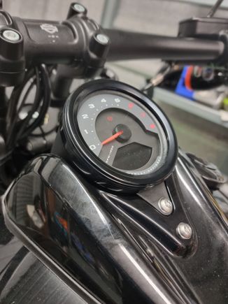 Harley black anodized bezel cover.The two bolts below the gauge will be black soon.