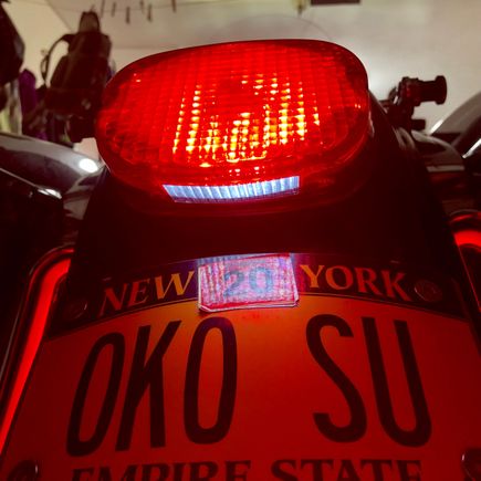 Aftermarket lens has white part facing downward.