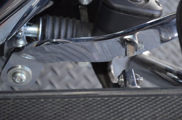 Notch in pedal arm to clear foot pad arm.