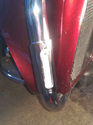 The plastic housing sticks out through the metal cover by about 1/8" or so, plus it's flush with the metal cover all the way around.  A smashed bead of silicone seals the plastic to the tubing all the way around, the metal cover just holds everything in place.