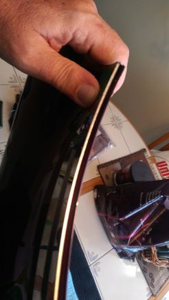 Never did get the darned stainless piece to fully conform to  the curvature.  It comes flat.  Both ends eventually un-bonded the 3M tape and stick out, but only 1/16 of an inch o so, so I'm OK with it, I guess.