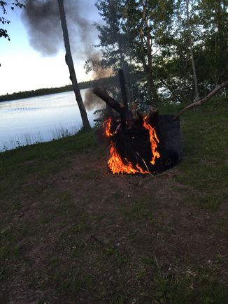 Burning the paint off the fire ring we made.