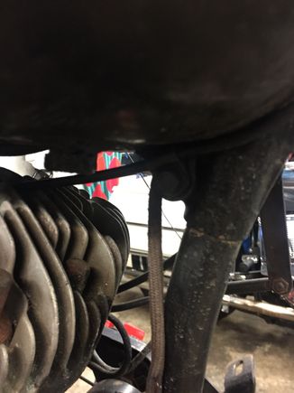 See the little bracket, you need that to hold the throttle cable housing to allow the inside cable move. It is held on by the tank bolt.