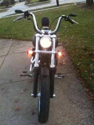 Front view lights on; High powered headlight bulb; smoked turn signals (relocated to forks); Fork lowers black powder coated; chrome axle covers