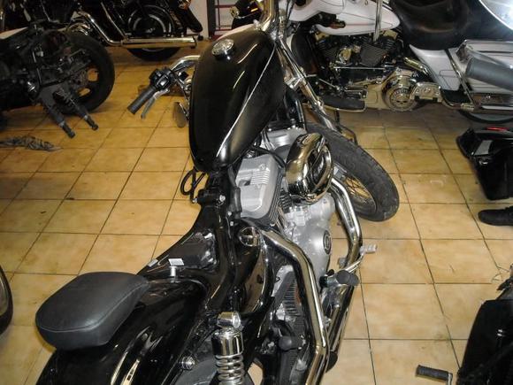 the paint job was done in in the carage with little prep and little cash , it was the creamy with the cherry line , i didnt like the look of the original tank, the passenger seat comes from the sissy bar back rest i still need to finish it , and the seat which you cant see , was cut out from the original plastic pan , i also shaved the foam down to make il low ,