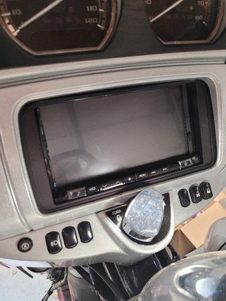 The round button on the left lights up blue when activated.