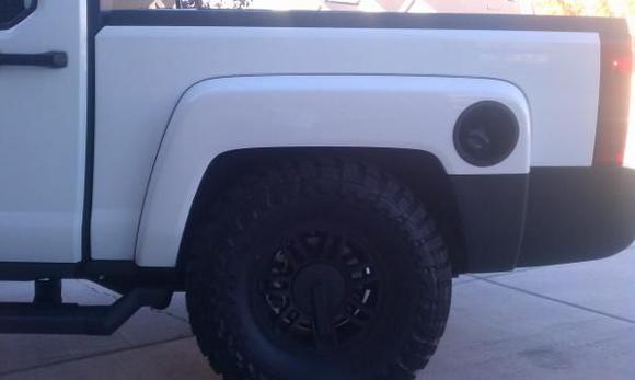 The T with the 35's stuffed into the wheel well. Try that with a stock jeep.