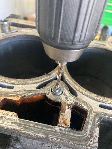 Start out a punch, then with a #2 drill bit (from the kit), then work up to a #3 drill bit.  Be careful not to drop (too much) metal in the cooling passages.  