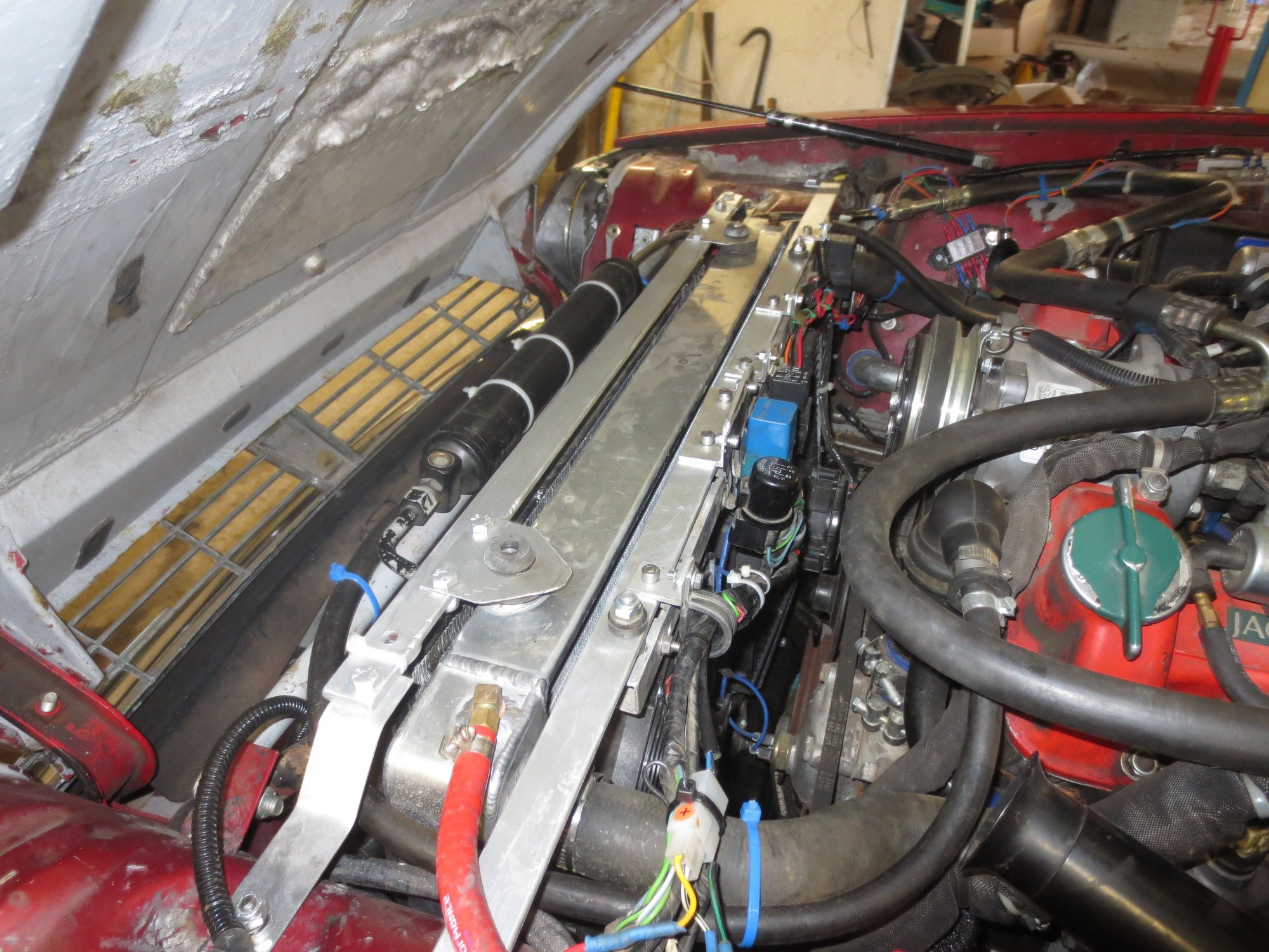 My radiator top fixings. The rearmost holds the electric fans and the front one secures the radiator, the aircon dryer and condenser top fixings. Loads more airflow through the engine bay.