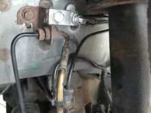 Used a short piece of aluminium bar to extend the cable and bolted it to the brake pipe bracket - there is a very convenient spare hole.