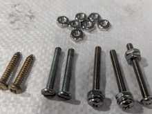 ST screws for horn push on left. Then 2 Jag screws, then better version. On right the shoulder screw.