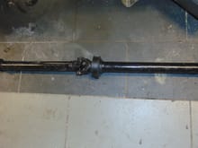 2 piece driveshaft.  Front half was shortend about 2 inches for the AJ16 / ZF (4hp24) drive train.  
Two peice was retained for smoothness.  At 52 inches, it's just beyond the 48 inch threshhold most consider acceptible for a 1 piece.  With the 3.54 gear and over drive that shaft is going to be high speed spinning so the smoothness of a two peice is worth the 45$ extra cost over a new grumbly 1 piece.