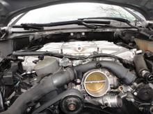 The valley hose running from the back of the engine along the left side of the left side intake manifold to the front, S-curves to the right side of the throttle body.