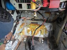 Wiring harness routed from inner fender wall across the firewall and down to run along the edge of the console.