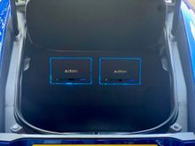 Two Forza amps sit behind alcantara covered beauty panel.