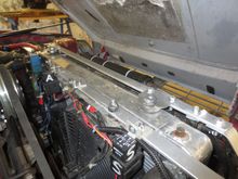 This is my car now, one strut locates the radiator and aircon condensor/oil cooler stack, and there is another locating the fans, which are fixed at the bottom to the chassis cross member to which studs are welded onto which brackets from the fans  are fixed