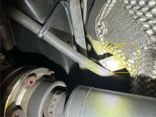 Here's where it was tucked behind the tunnel heat shield 