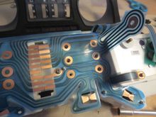 Flexible circuit board, showing the holes through which the minor guage screws go, they scure the instrument and make the electrical contact