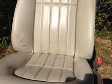 Passenger seat out of the car. showing hte wear along the side bolster.