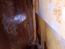 Through the sending unit opening at the rear LH tank.  Bottom of tank is icky.  Most fuel leaked out of that screw; the one above the drain.  WHY, just why would you put a screw there?  It seems to have no purpose.