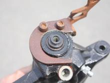 If you look closely, you can see a brown ring between the shaft and the body of the caliper.  That is rust.  The shaft has rusted to the body, resulting in the e-brake not being able to move.  You need to remove this rust.