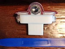 Use a trim tool to remove the OEM light.