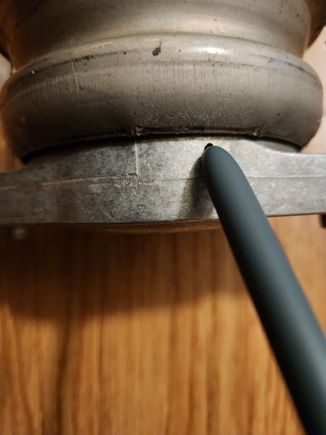 I scribed right where my pen is pointing. Where the mount meets the base. Drain all fluid in mount and cut the ring on both sides. The sides will break off. After that gut the mount completely until only the bottom dish is left. Now grind the base portion down to where your scribe is. There is also a small ring at the bottom of the base that is slightly raised. I ground this smooth as well.