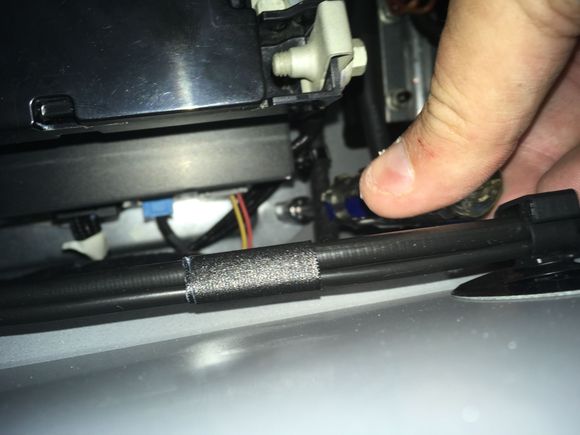 21. Carefully slide the driver onto the front nut and unwind it.