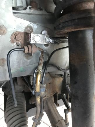 Used a short piece of aluminium bar to extend the cable and bolted it to the brake pipe bracket - there is a very convenient spare hole.