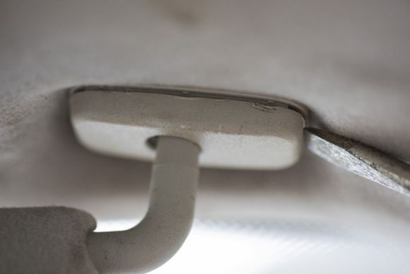 Unclip cover to reveal screws.