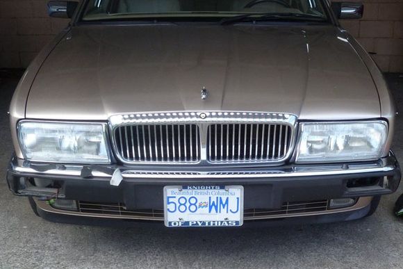 The damaged front bumper rubber, left corner torn. Lights unplugged and set aside.