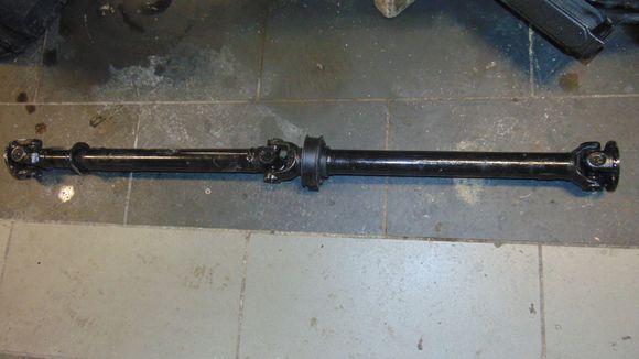 2 piece driveshaft.  Front half was shortend about 2 inches for the AJ16 / ZF (4hp24) drive train.  
Two peice was retained for smoothness.  At 52 inches, it's just beyond the 48 inch threshhold most consider acceptible for a 1 piece.  With the 3.54 gear and over drive that shaft is going to be high speed spinning so the smoothness of a two peice is worth the 45$ extra cost over a new grumbly 1 piece.