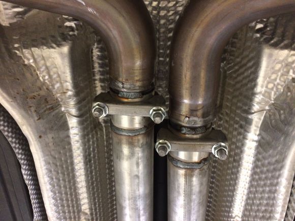 The new pipes slip onto the stock front pipes and clamp down. This is so I can remove new pipe and reinstall stock center at any time. The "bead" flange is undamaged. We just put a very small tack weld to keep it from moving/turning over time. Can be ground down if I want to go back to stock.