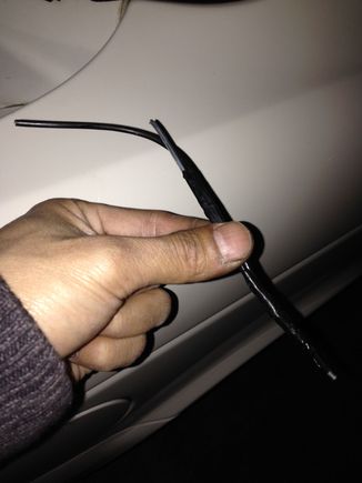 Get yourself about 7 inches of a metal hanger. Tape your wire to the hanger on one side depending if your running up or down the boot. I decided to go down.

feed it through the first opening. Then half way in that loom cut a small slit so you can poke the tip through. Do it gently and watch out for the other wires.

Mine went through smooth first try

After that you will be able to reach the end though that middle slit