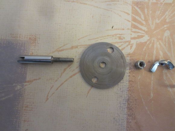 From left to right: Shouldered spindle with 5mm threaded top, disc, locknut to lock disc to spindle shoulder, wingnut to be attached to threaded part with permanent Loctite 270 to act as adjuster and counter-torque when doing up the locknut.