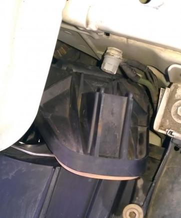 Wiggle cover in place, push cover down to insert tab into wire spring.   :)