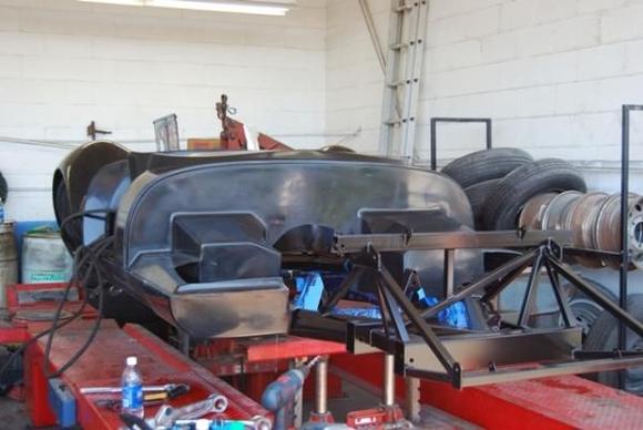 The entire body weighed in at about 120 lbs.  Pretty cool.  Of course, it only looked like this until it met my sawsall!!  Next we moved the body to the Lucra shop in Oceanside CA where, with their help, my brother and I started bonding the body to the frame.  After cutting off all of the mold flashings and cutting the body to slide down over the frame, we were able to begin the bonding process.  Because of our limited time (both of us had to be at work on Monday) we worked very long hours and typically locked up well after the Lucra folks had left at night.