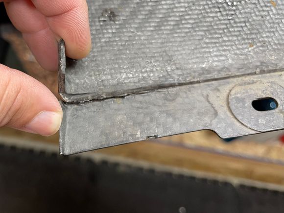Pre-existing damage.  I think this could be fixed with some epoxy, and it's way under the car where no one would see it unless they're on their back.