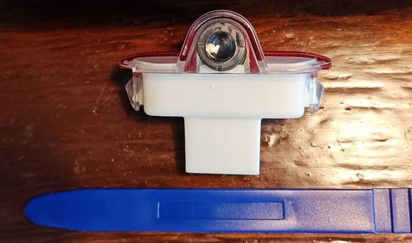 Use a trim tool to remove the OEM light.