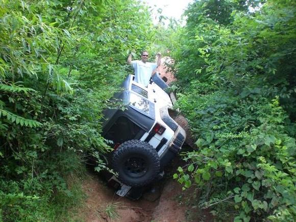 The ground gave way on the rear tire and Jeep rolled onto it's side - actually put it in reverse and backed out of this.  JK's are unreal.