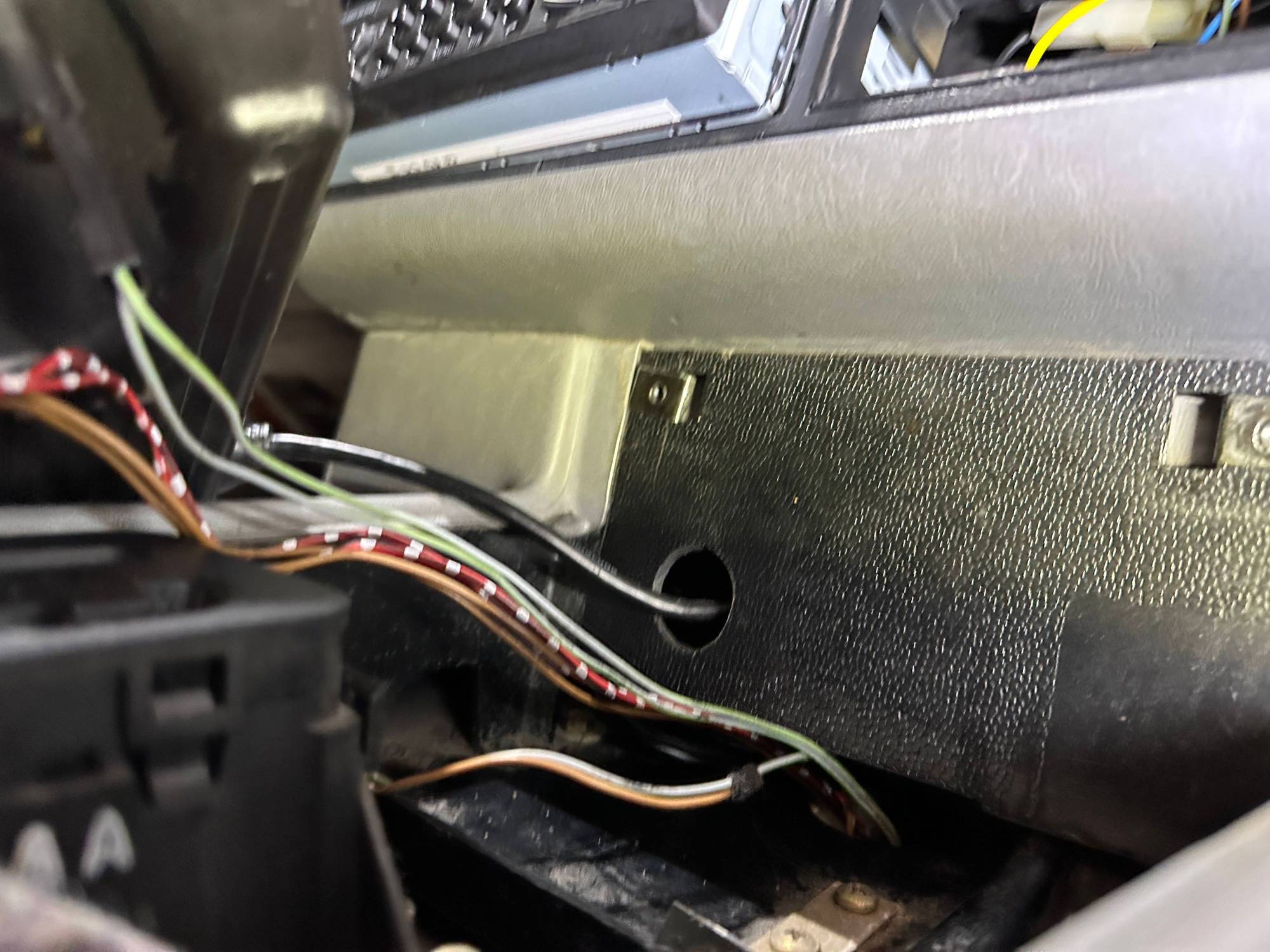 cover at front where it sits underneath the leather trim above from the upper center console where radio & oddments tray is located.