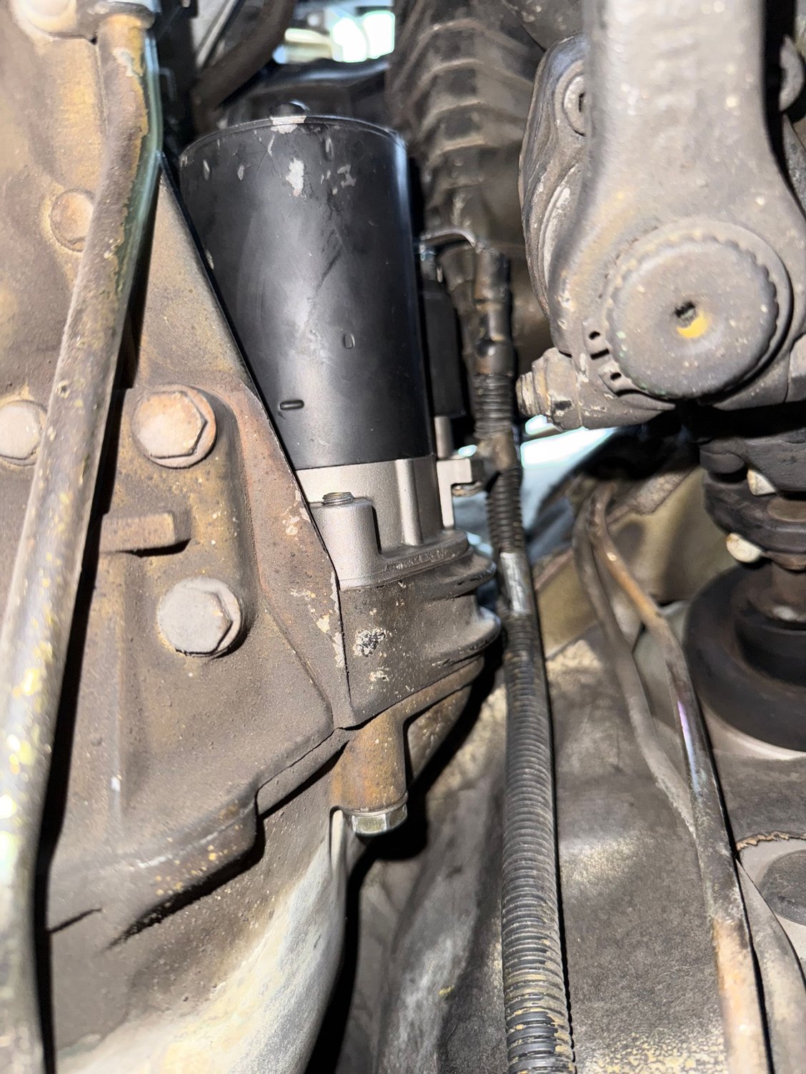 Located on the driver side. Main starter wire shown here running alongside the starter.