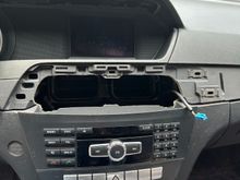 The wood grain trim piece pops right off too. Start away from the radio and work towards it. Inside the vents are two latches one on each end. You can get at them thru the vent or wiggle them lose with some  pressure and patience. Unplug any plugs that you mighty have hooked up to your vents.