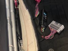 Once the plastic cover thing is pulled out of the way you can see the harness and stock module at the front of the car clearly. Undo the pink connector going into the front Mercedes module by sliding/rotating/moving the black part of the connector slowly and it will all work itelf apart.