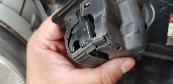 bottom of plastic housing tab on hood lock mechanism
