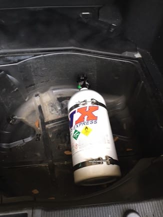Bottle installed in wheel wheel, facing forward, and bottle nozzle downward. The bottle is at a 15 degree angle. The nitrous line is connected to bottle and can go under the rear seats into cabin, and hide line under seat and along trim on drivers side