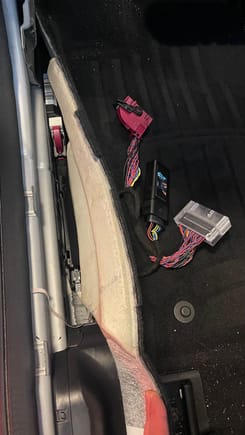 Once the plastic cover thing is pulled out of the way you can see the harness and stock module at the front of the car clearly. Undo the pink connector going into the front Mercedes module by sliding/rotating/moving the black part of the connector slowly and it will all work itelf apart.