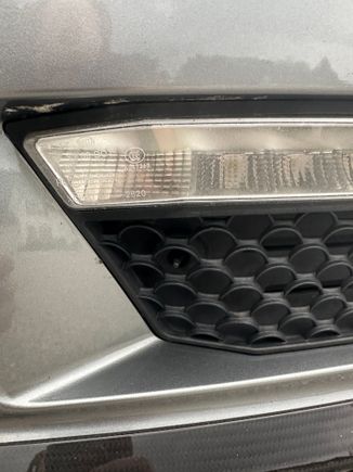Pfl 63. Every Mercedes I’ve had 03-13 had has had it in the same place. You can even see the little hole right next to your fog light. And quite honestly, that fog light doesn’t look proper because Mercedes does not leave external screws like that. 