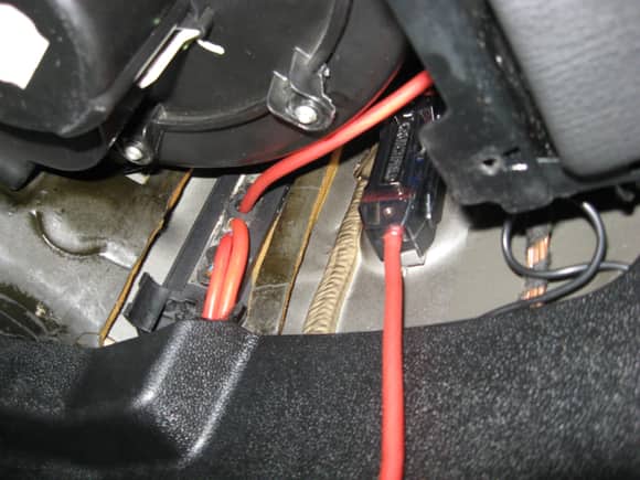 Fuse holder in the passenger footwell area